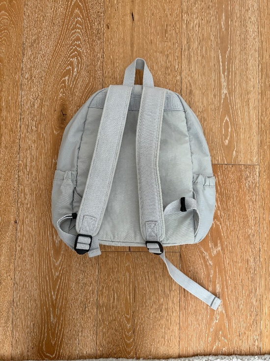 Grey Kipling backpack with monkey keychain